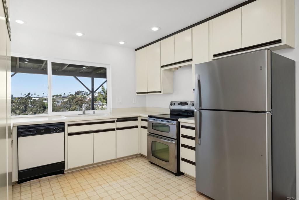 664 Mariposa Circle Chula Vista, CA 91911 - Photo 7 of 34 a kitchen with stainless steel appliances a refrigerator and a stove top oven