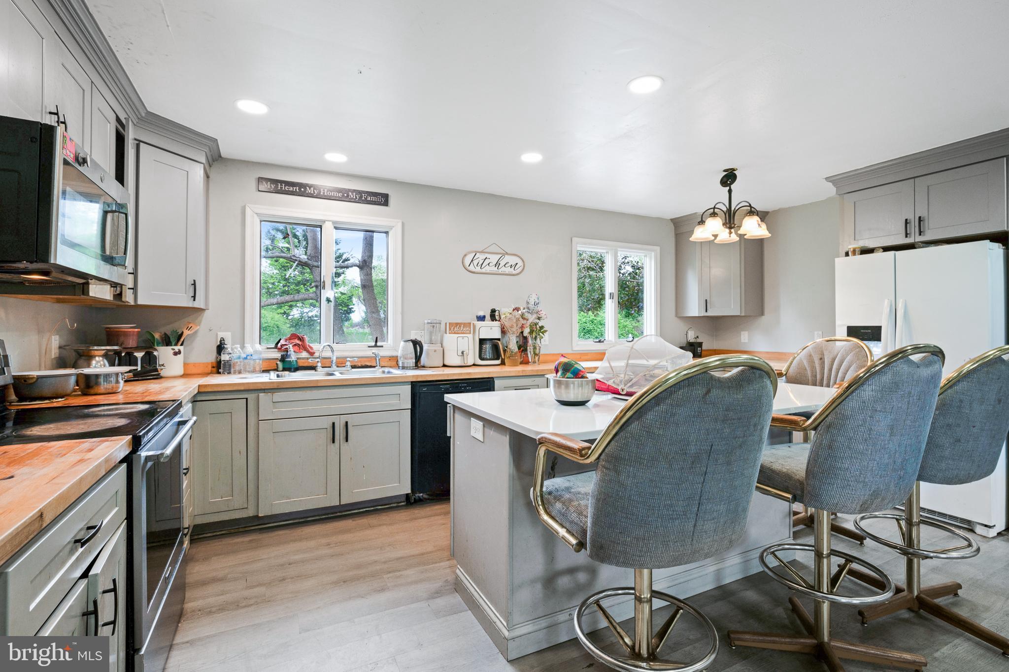 1731 Limestone Road Cochranville, PA 19330 - Photo 6 of 29 a kitchen with sink a refrigerator and chairs
