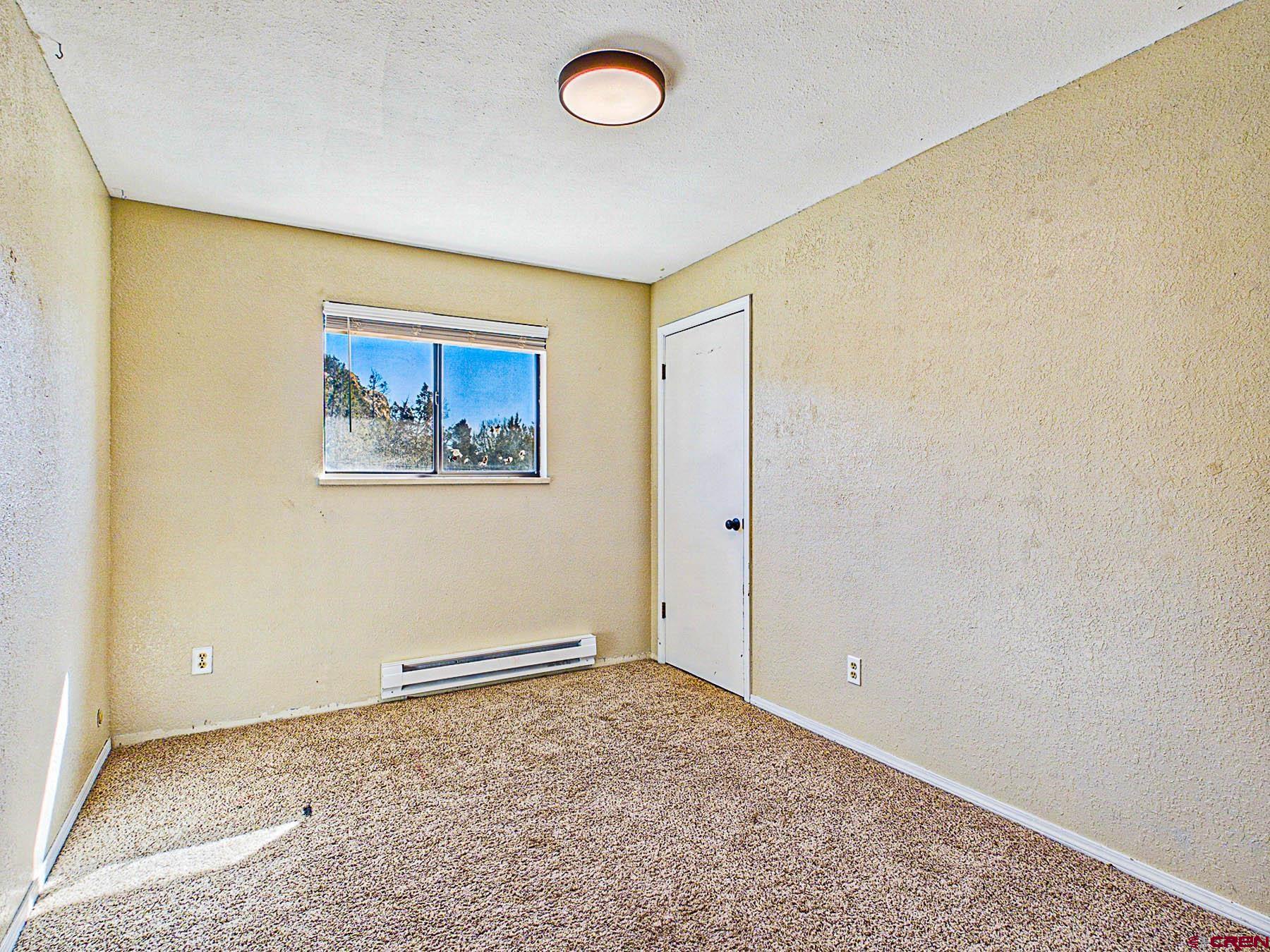 18697 Ward Creek Road Cedaredge, CO 81413 - Photo 21 of 45 an empty room with a fan