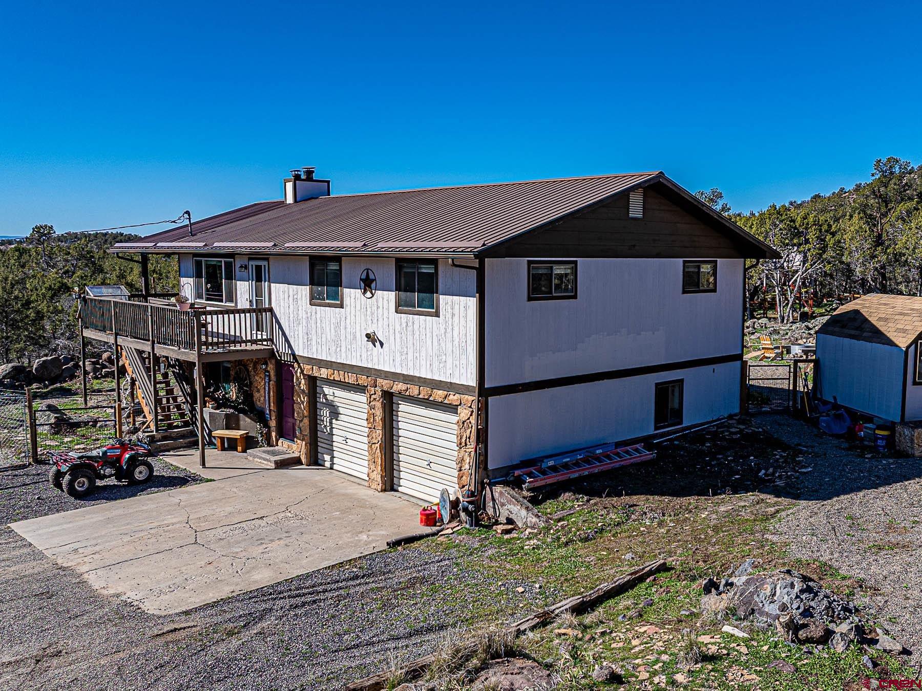 18697 Ward Creek Road Cedaredge, CO 81413 - Photo 3 of 45 a view of a house with a yard