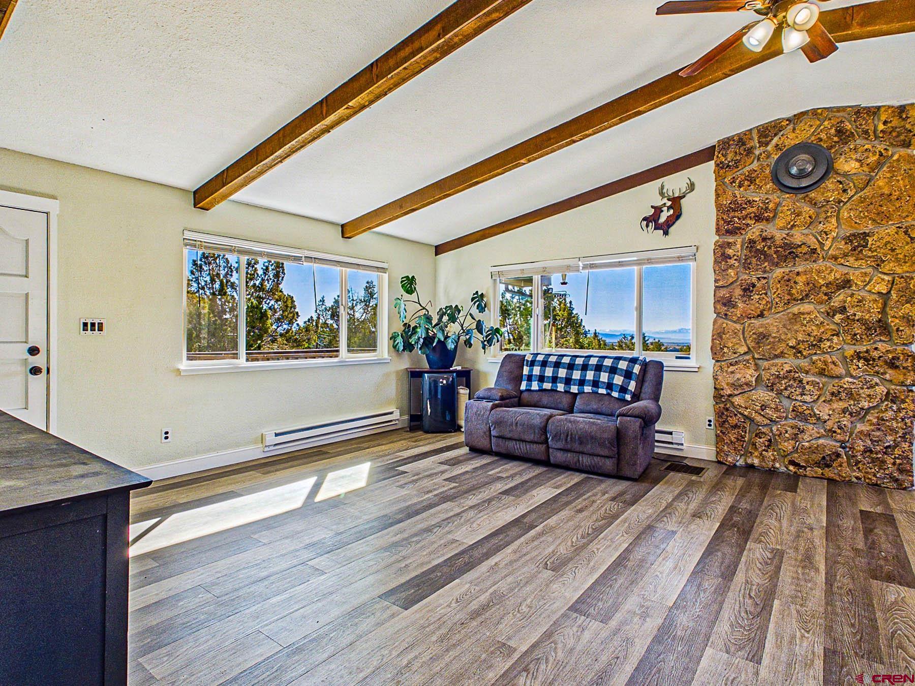 18697 Ward Creek Road Cedaredge, CO 81413 - Photo 10 of 45 a living room with furniture and a wooden floor