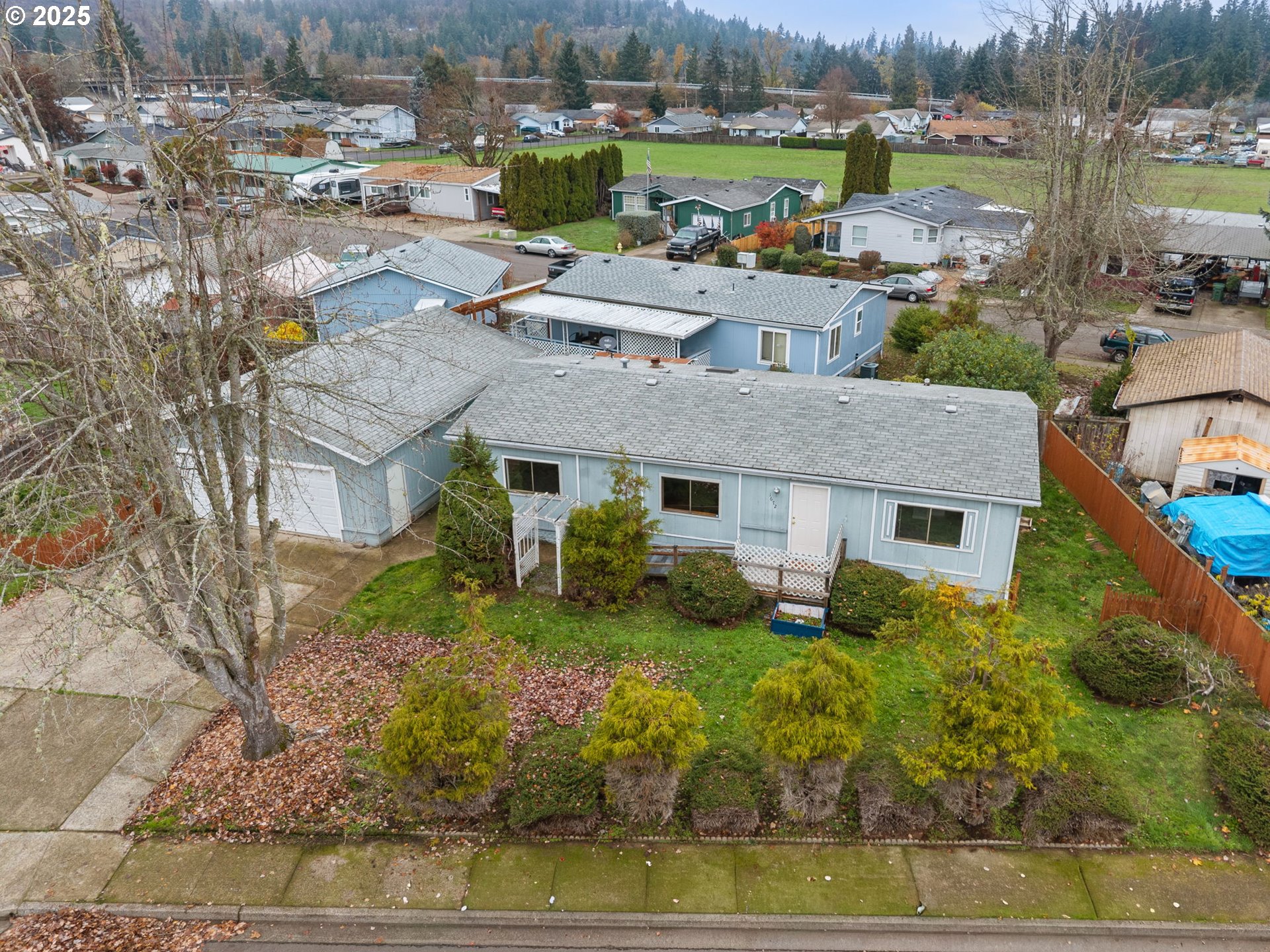 a aerial view of a house with garden and lawn chairs