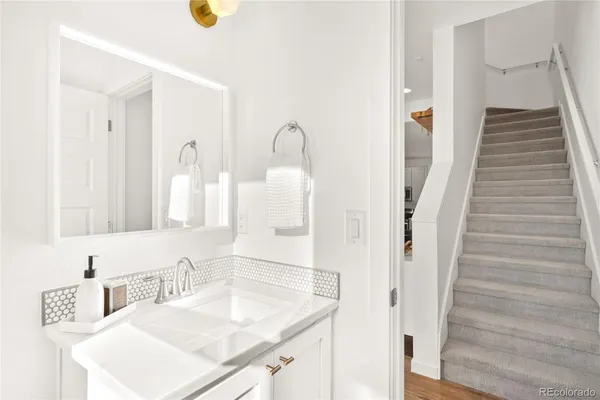 a bathroom with a sink vanity and a mirror