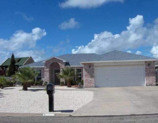 15873 Punta Espada Loop Corpus Christi, TX 78418 - Photo 1 of 1 a front view of a house with a yard and garage