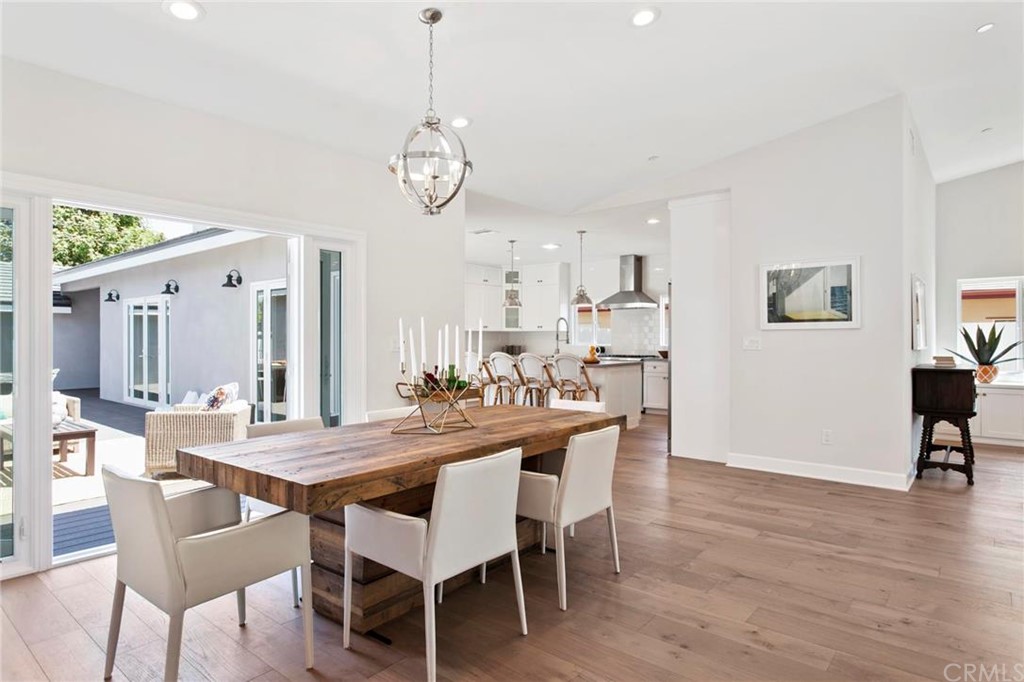 262 Esther Street Costa Mesa, CA 92627 - Photo 1 of 1 a view of a dining room and livingroom with furniture wooden floor a rug a painting and a chandelier