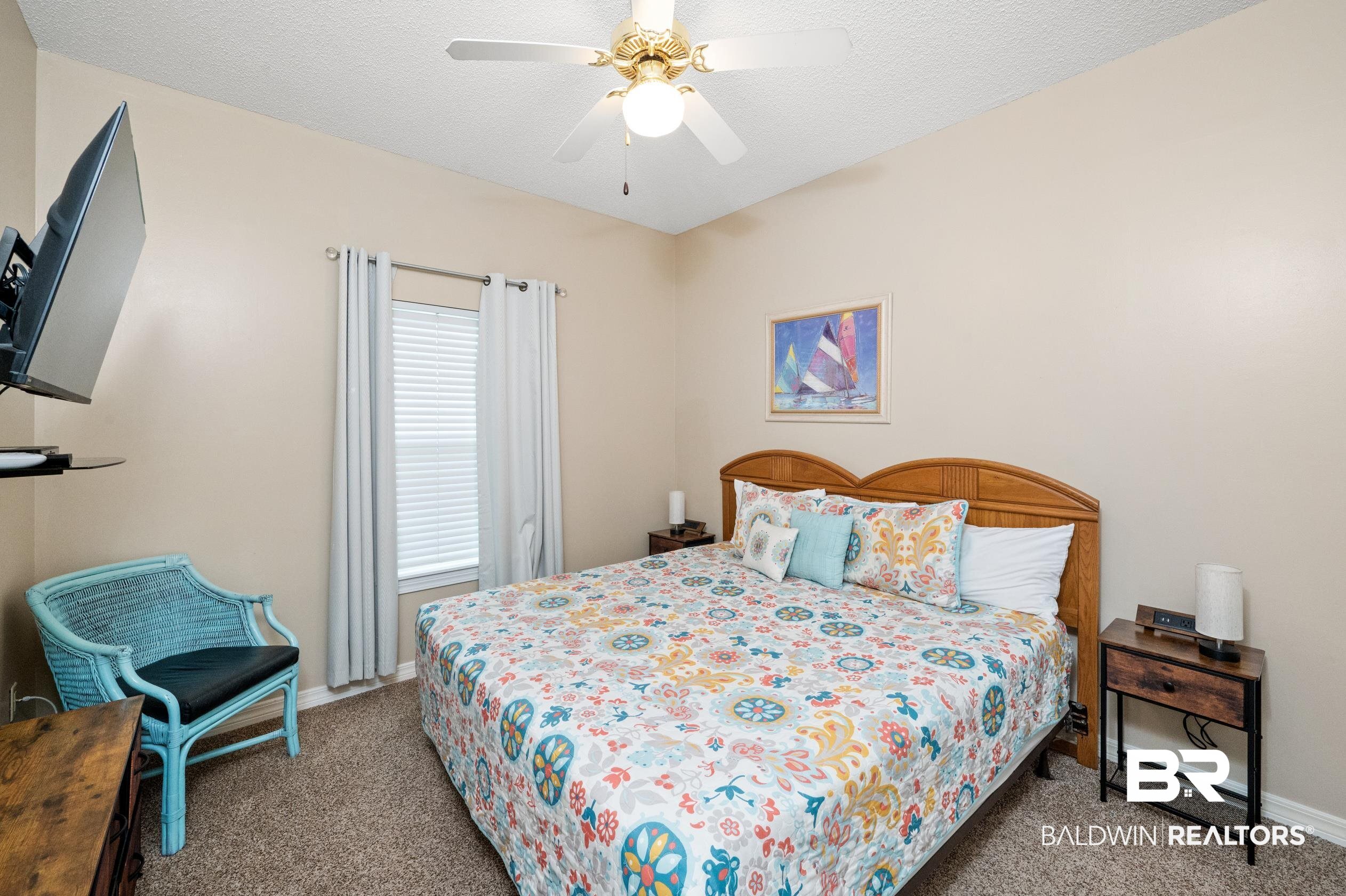 1380 Fort Morgan Road, Unit 106 Gulf Shores, AL 36542 - Photo 9 of 20 Carpeted bedroom with ceiling fan, a textured ceiling, and baseboards