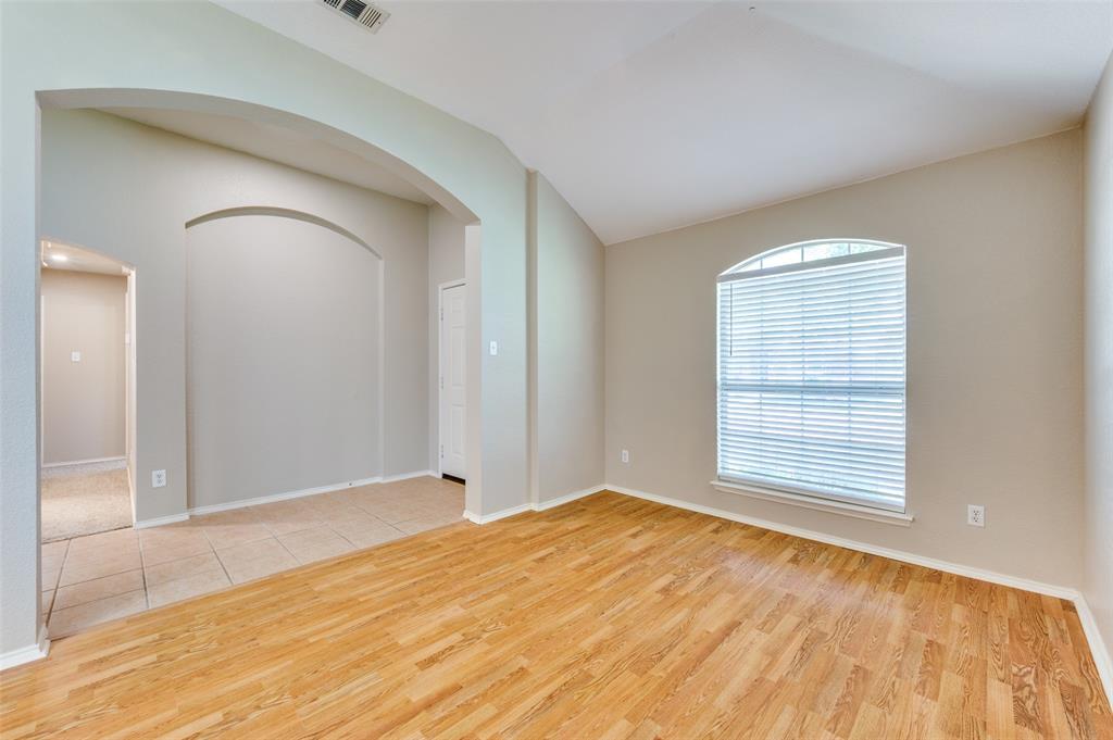 1117 Red Hawk Drive Frisco, TX 75033 - Photo 19 of 31 a view of an empty room with wooden floor and a window