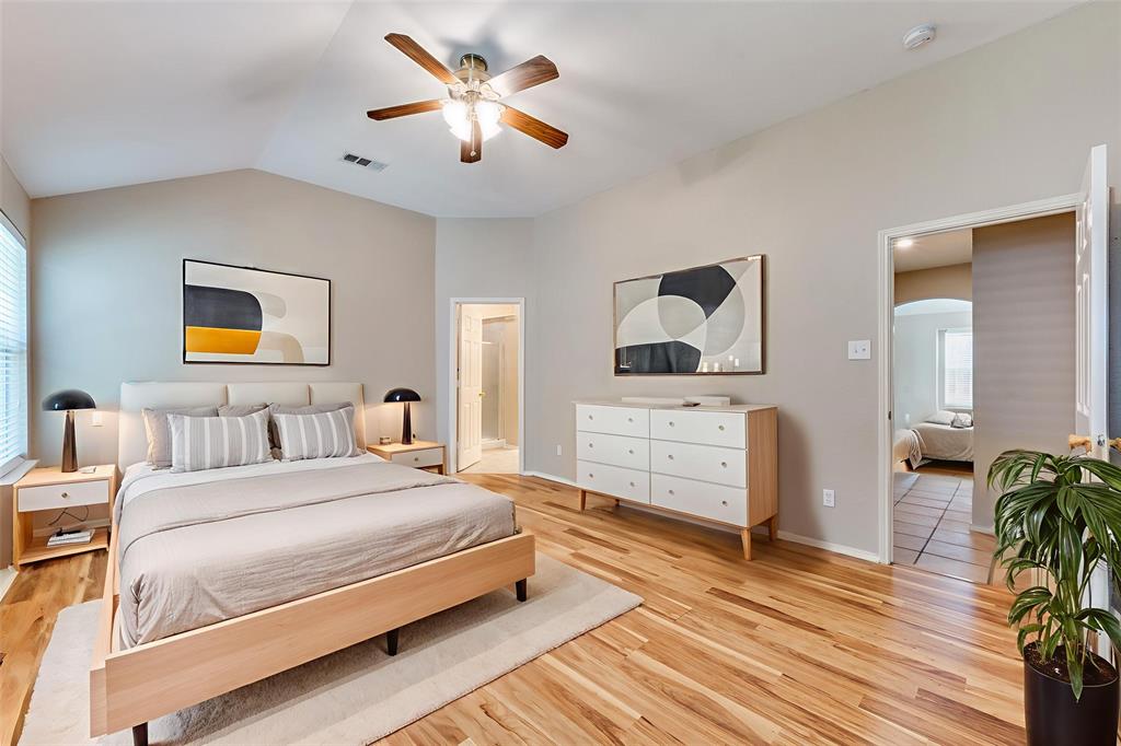 1117 Red Hawk Drive Frisco, TX 75033 - Photo 24 of 31 a bedroom with a bed lamp and paintings on the wall