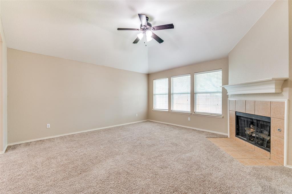 1117 Red Hawk Drive Frisco, TX 75033 - Photo 3 of 31 a view of an empty room with a fireplace and a window