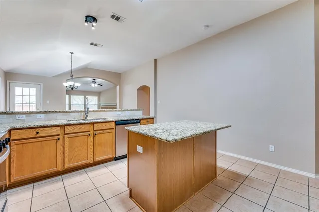 a kitchen with granite countertop a sink and cabinets