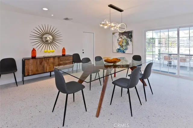 a view of a dining room with furniture and chandelier