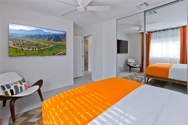 a bedroom with a bed and a chair