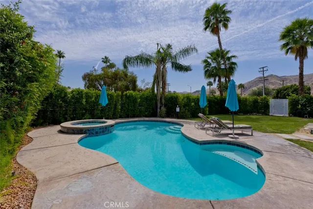 a view of a swimming pool with lounge chair