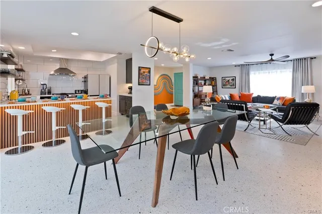 a view of a dining room with furniture a chandelier and wooden floor