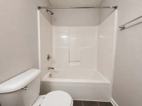 a bathroom with a toilet and a bathtub