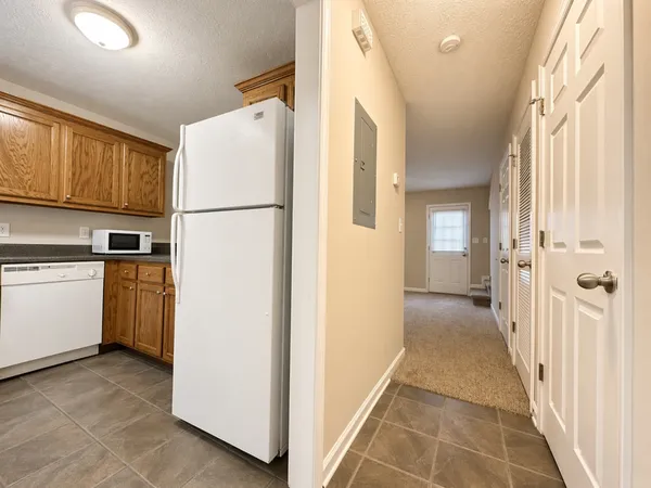 a view of a kitchen with a refrigerator a microwave and a sink