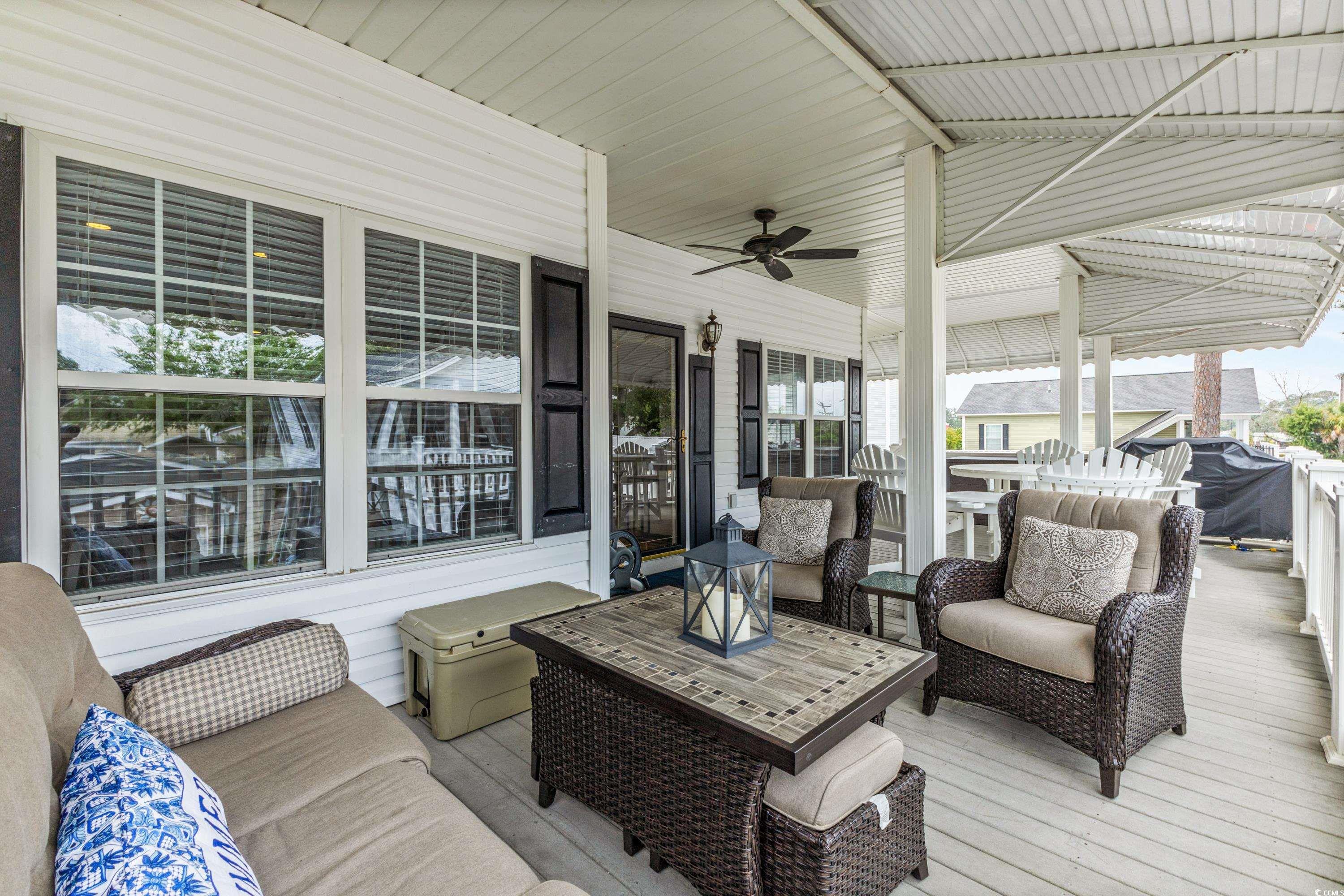 6001-1846a South Kings Highway Myrtle Beach, SC 29575 - Photo 11 of 40 Wooden deck with outdoor lounge area and ceiling fan