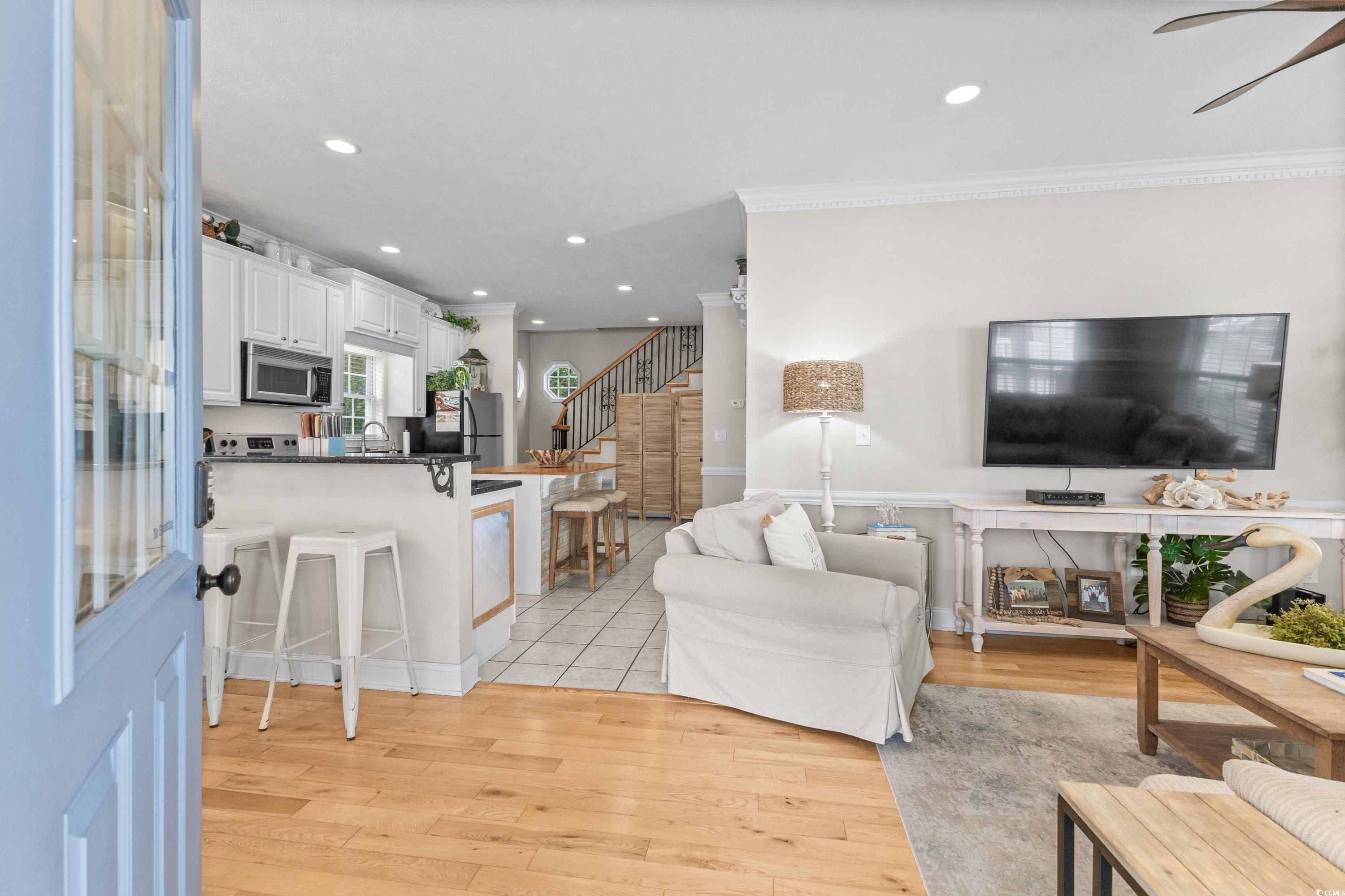 6001-1846a South Kings Highway Myrtle Beach, SC 29575 - Photo 12 of 40 Living room featuring light hardwood / wood-style floors, crown molding, sink, and ceiling fan