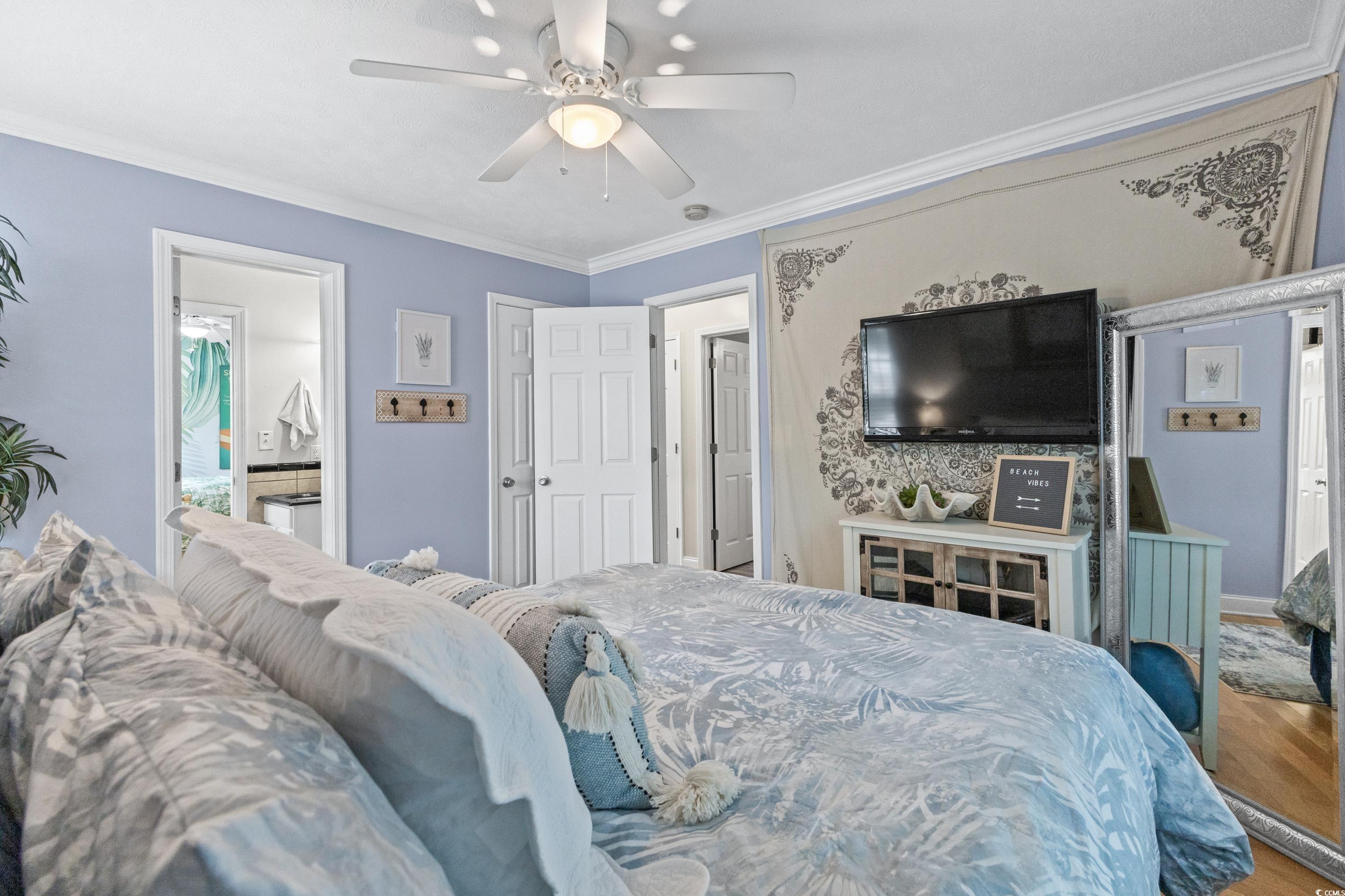 6001-1846a South Kings Highway Myrtle Beach, SC 29575 - Photo 30 of 40 Bedroom with crown molding, ceiling fan, and hardwood / wood-style flooring