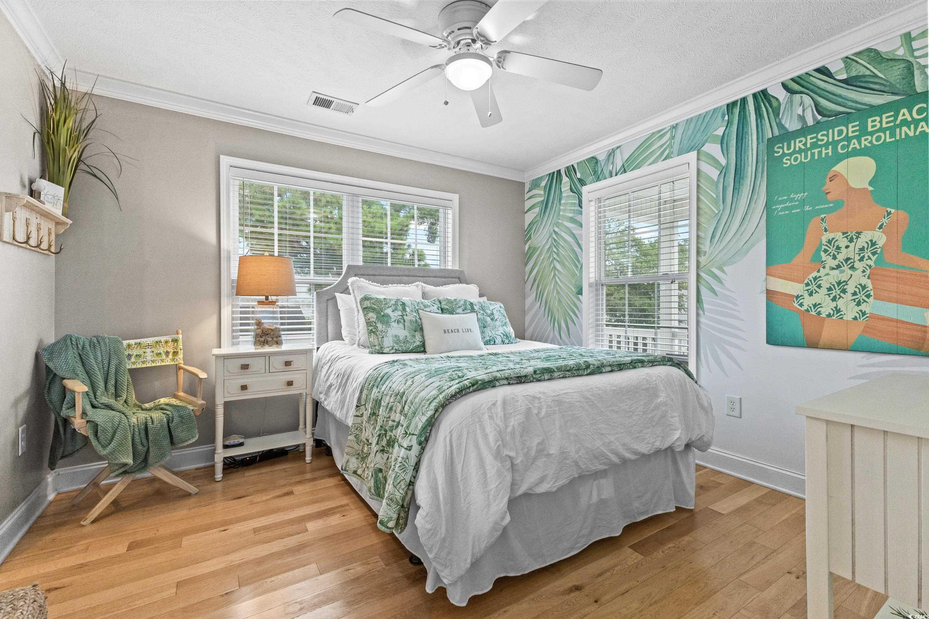 6001-1846a South Kings Highway Myrtle Beach, SC 29575 - Photo 33 of 40 Bedroom featuring a textured ceiling, crown molding, light wood-type flooring, and ceiling fan