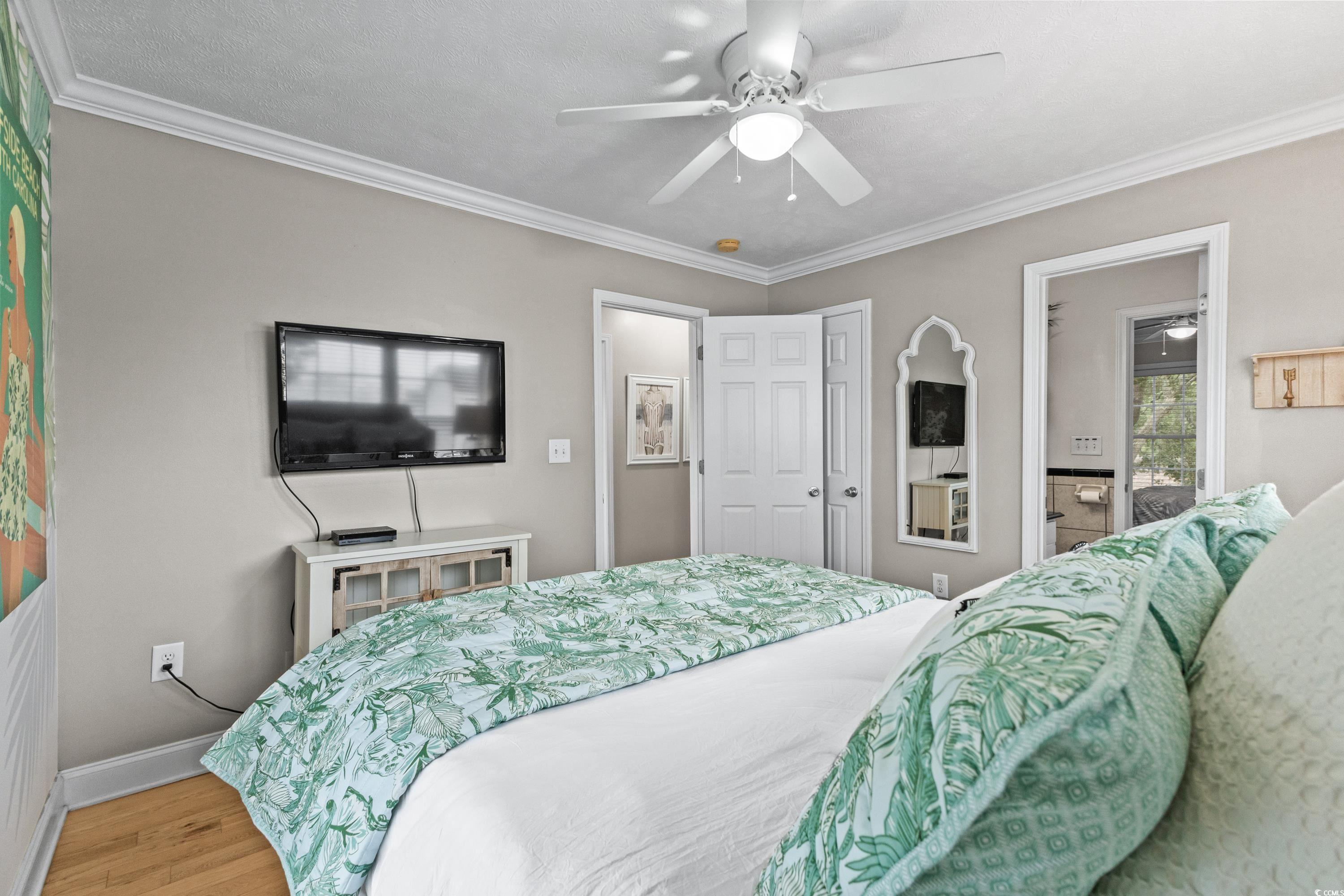 6001-1846a South Kings Highway Myrtle Beach, SC 29575 - Photo 34 of 40 Bedroom featuring wood-type flooring, crown molding, and ceiling fan