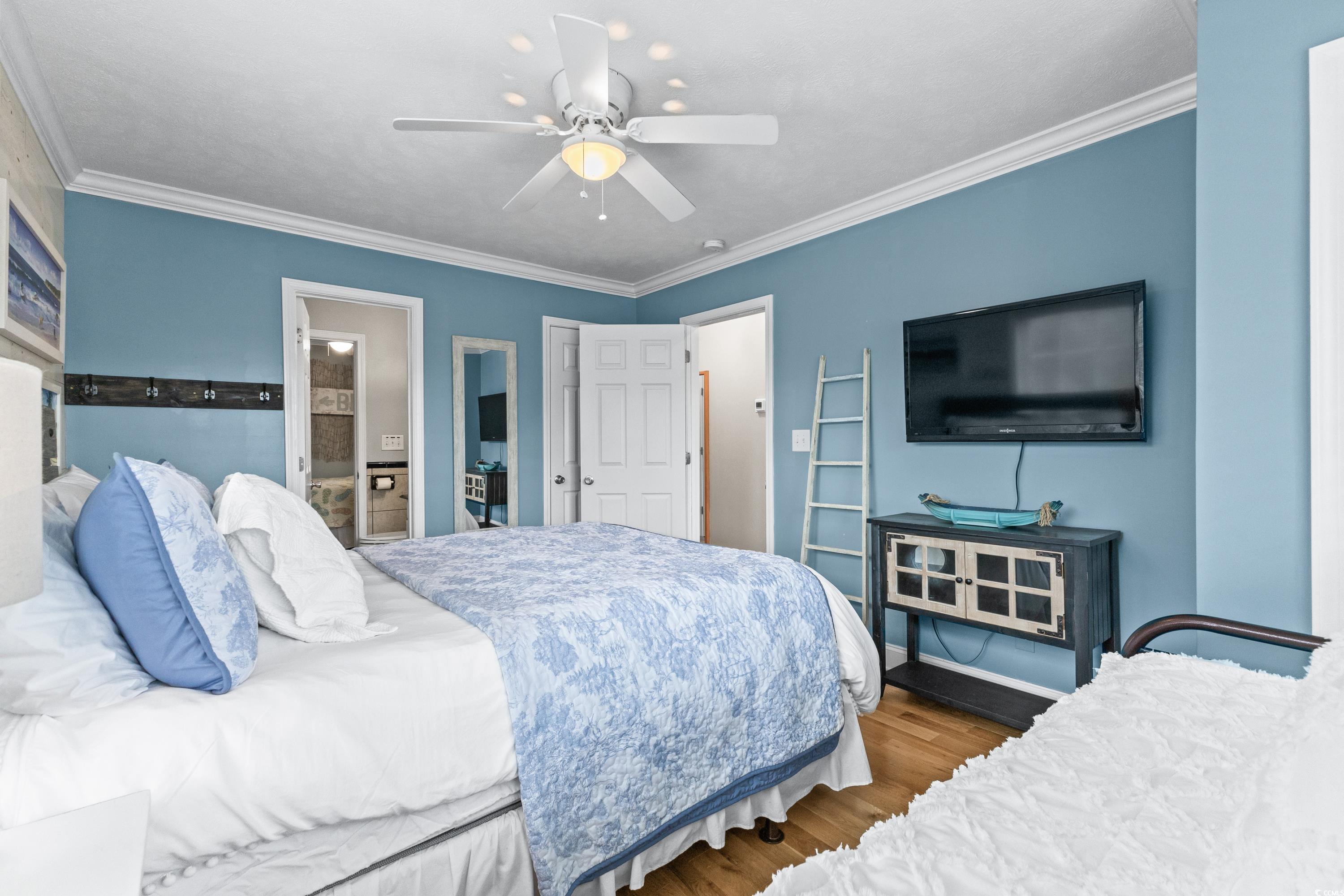 6001-1846a South Kings Highway Myrtle Beach, SC 29575 - Photo 36 of 40 Bedroom featuring ornamental molding, ceiling fan, and hardwood / wood-style floors