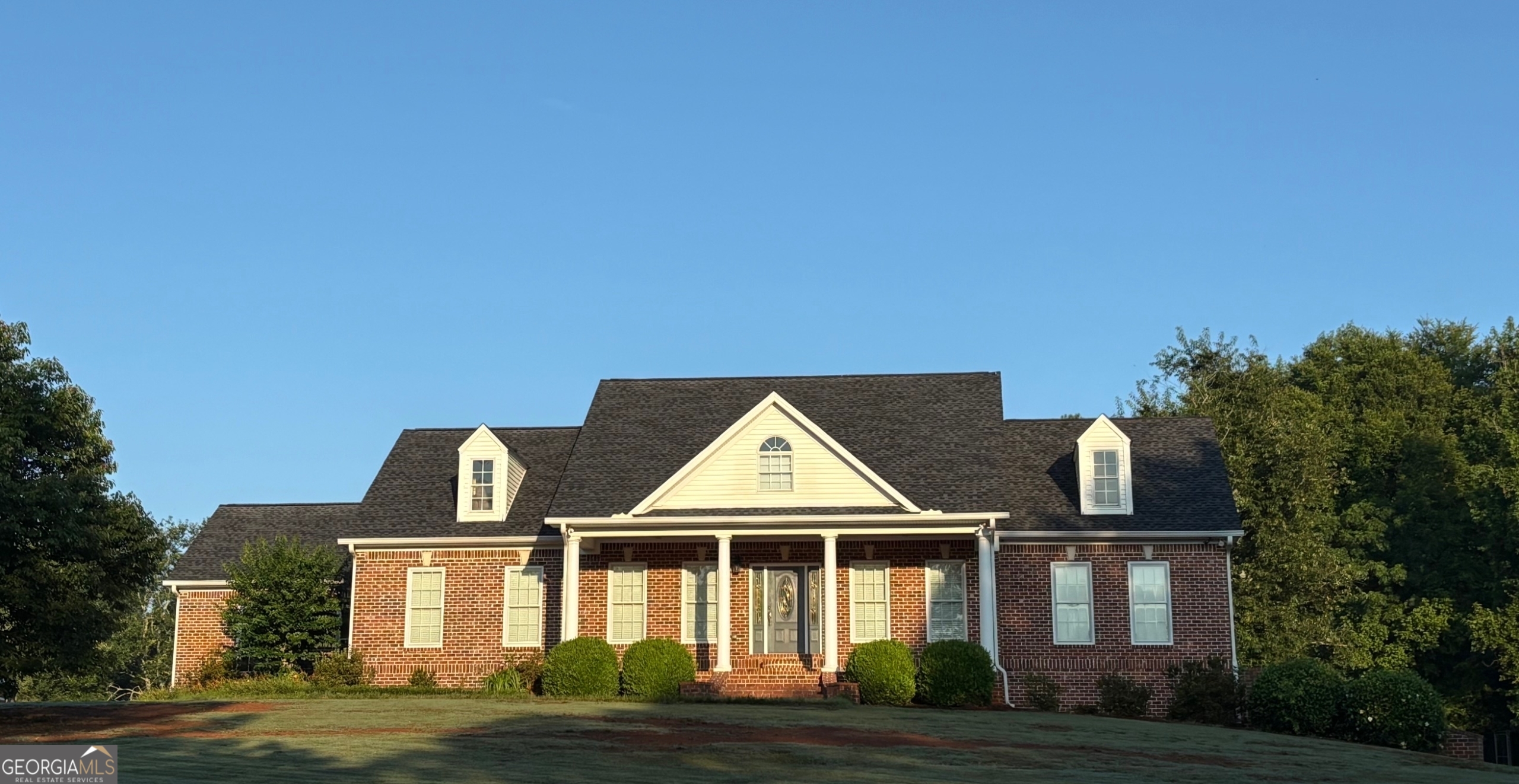 a front view of a house with garden