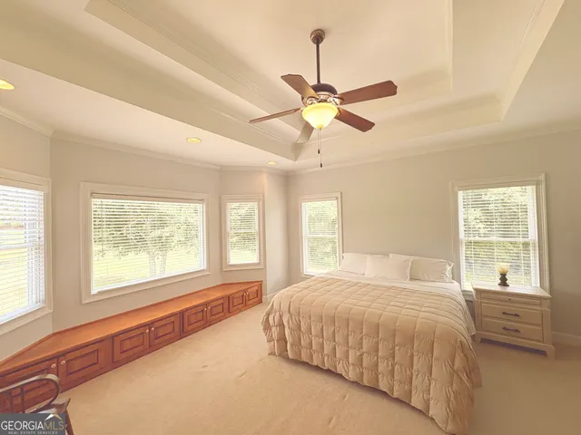 a spacious bedroom with a large bed and a window