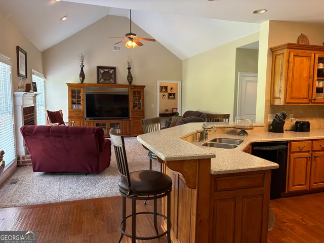 a kitchen with a stove a sink and a refrigerator