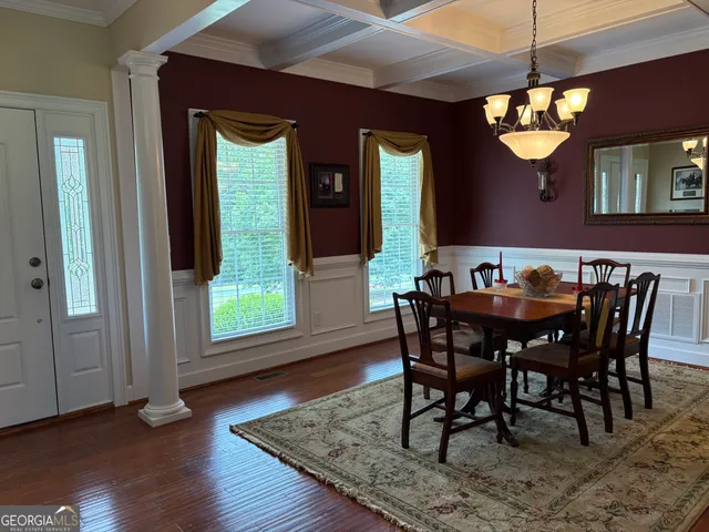 a view of a dining room with furniture window and wooden floor