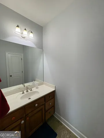 a bathroom with a sink vanity and a mirror