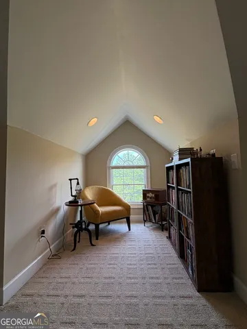 a living room with furniture a window and gym equipment