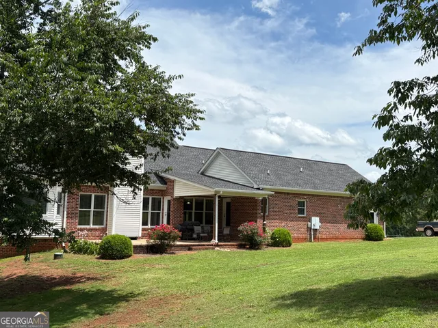 a view of a house with a yard porch and sitting area