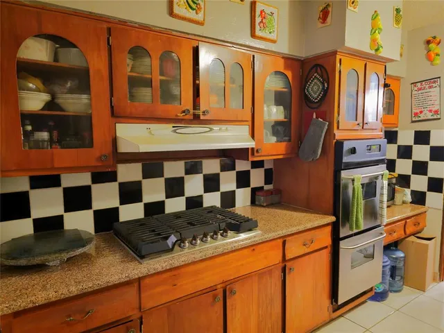 a kitchen with a stove a sink and a refrigerator
