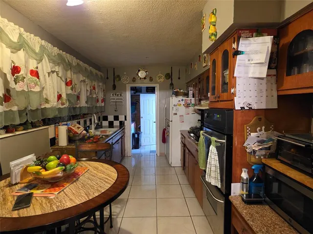 a kitchen with a sink and a stove top oven