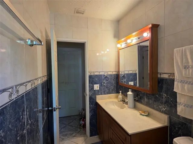 a bathroom with a sink double vanity and a mirror