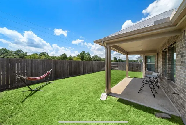 an aerial view of residential houses with outdoor space and lake view