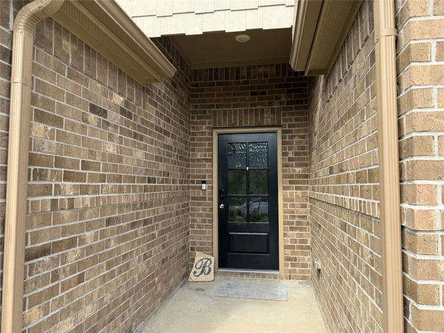 a view of gallery with wooden floor and windows