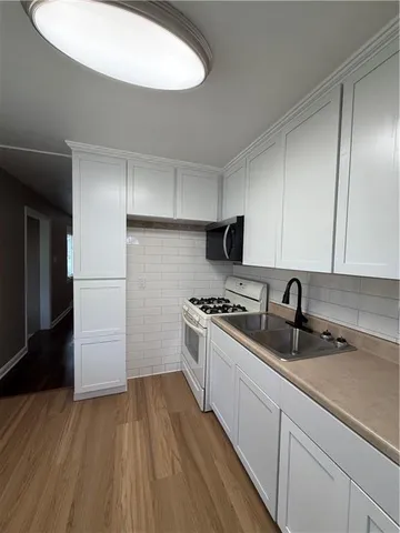 a kitchen with a sink a stove and refrigerator