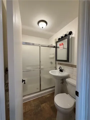 a bathroom with a toilet sink and shower