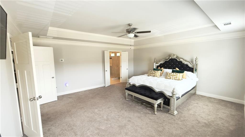 3370 Elkhorn Ridge Run Dacula, GA 30019 - Photo 16 of 29 a bed sitting in a room next to a window