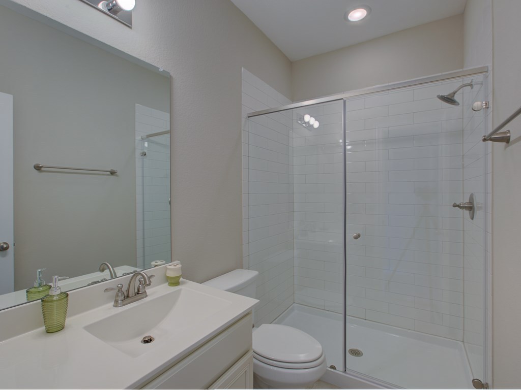 4303 Logan Ridge Drive Cedar Park, TX 78613 - Photo 15 of 24 Bathroom featuring a vanity with an integrated sink, brushed nickel faucet, and an overhead mirror