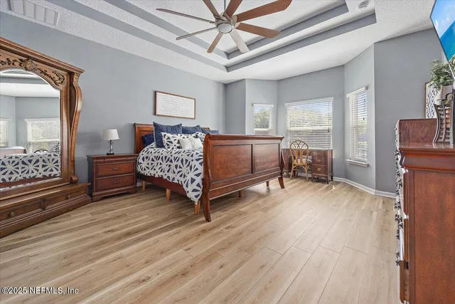 a bedroom with a bed and a chandelier