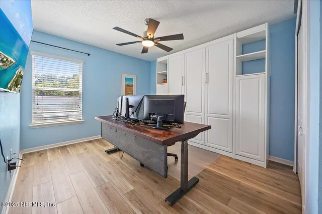 a view of workspace with wooden floor windows