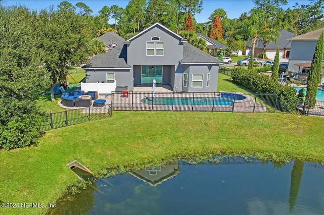 a view of a house with a yard patio and sitting area