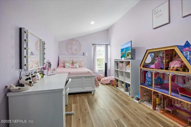 a living room with furniture a baby crib and a book shelf