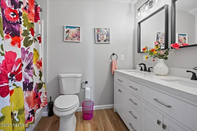 a bathroom with a sink mirror vanity and toilet