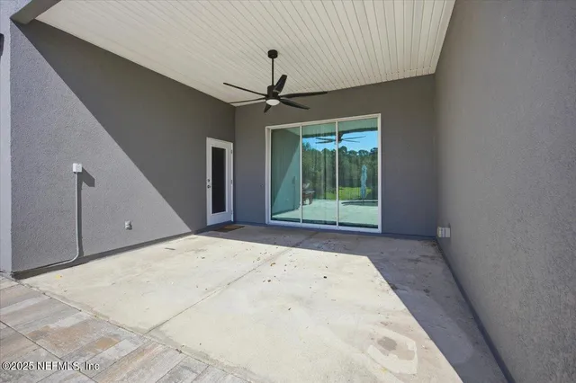 a view of a livingroom with a ceiling fan and window