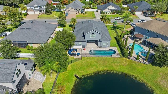 an aerial view of a house with yard swimming pool and outdoor seating