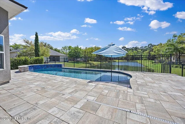 a swimming pool with a outdoor seating and yard